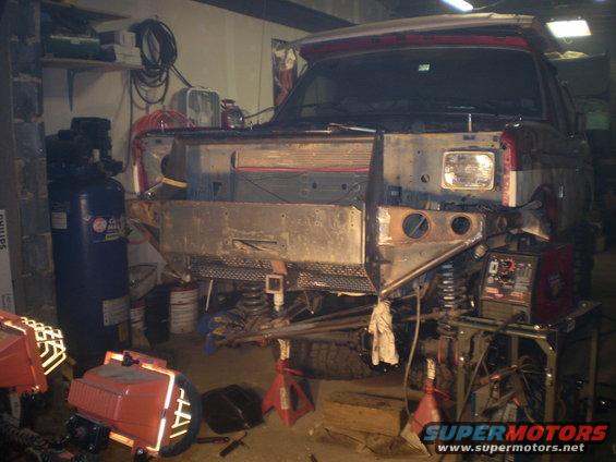 Ford Bronco front end disassembled in a workshop, with custom bumper fabrication