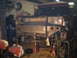 1986 Ford Bronco - The front end of a Ford Bronco is being worked on in a garage, with welding equipment nearby.