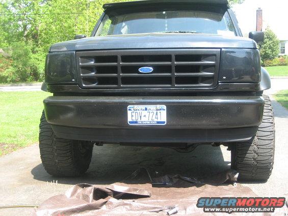 Front view of a black Ford Bronco with a grille that looks like it's from the early 90s