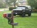 1995 Ford Bronco - A black SUV sits on a grassy lawn in front of a house, with a unique mailbox in the foreground.