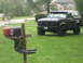 1995 Ford Bronco - Black Ford Bronco parked on a lawn next to a mailbox decorated with flames and checkered flags.
