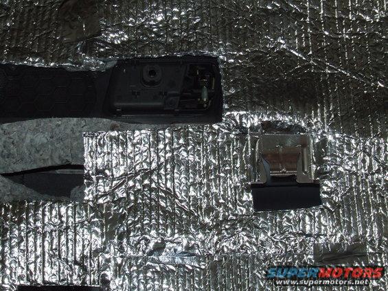 Car door panel removed showing sound deadening material and internal components