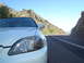 1997 Ford Probe - A white car is seen from the front passenger side on a scenic mountain road.