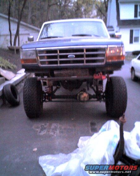 Front view of a blue 1996 Ford F-150 truck with lifted suspension