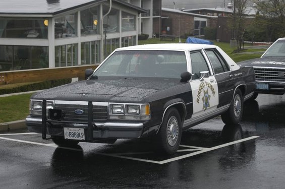 Black and white highway patrol car with push bumper and "Highway Patrol" text on door