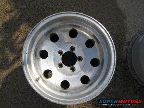 Aluminum wheel with 5 lug holes and 8 circular cutouts