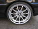 2002 BMW 3 Series - Close-up of a chrome BMW wheel, the brand's iconic logo, on a black vehicle.
