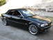 2002 BMW 3 Series - Black 2002 BMW 3 Series convertible parked outdoors with the top down.
