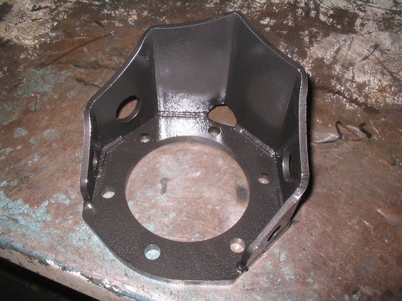 Black metal bracket with circular opening and bolt holes