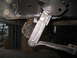 1979 Ford Bronco - A close-up view of a vehicle's suspension system and a horn, with no clear year identification.