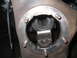 1979 Ford Bronco - Brake caliper bracket assembly with attached brake hose.