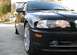 2002 BMW 3 Series - A black 2002 BMW 3 Series sedan is parked in a driveway, showing its front end and side profile.