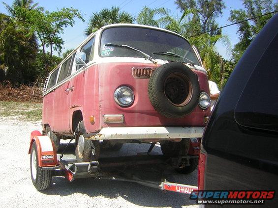 Front view of a red and white 1971 Volkswagen Vanagon on a U-Haul trailer