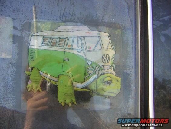 Drawing of a Volkswagen bus on a turtle's shell, stuck to a window
