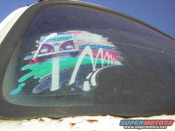 Sticker of a purple and white Volkswagen bus on a window
