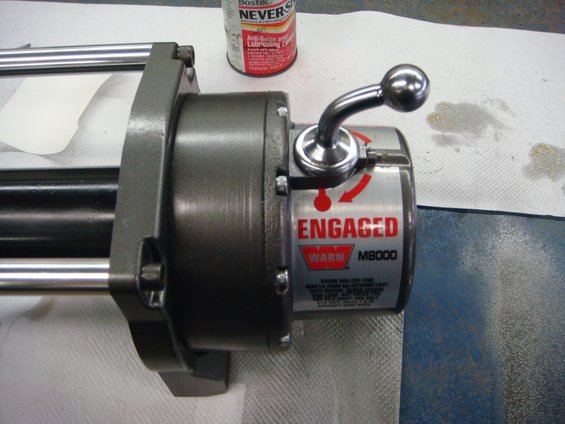 Close-up of a metal part with a lever and some red markings