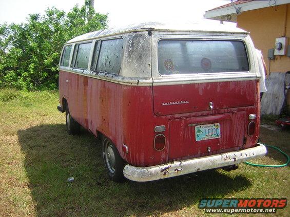 Rear view of a red and white 1971 Volkswagen bus with a Florida license plate