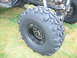 1992 Ford Mustang - Close-up of a large, knobby tire and suspension components on a custom off-road vehicle.