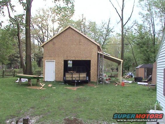 Garage under construction with trailer visible inside the opening