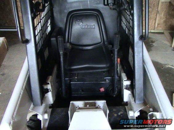 Bobcat skid steer loader interior with black seat and controls