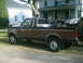 1991 Ford F-250 - Side view of a 1991 Ford F-250 pickup truck with custom dual exhaust stacks and a toolbox.