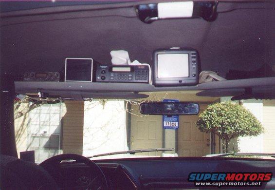 Interior view of a vehicle with aftermarket screens mounted above the dashboard