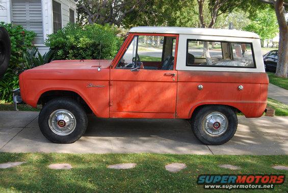 1977 Ford Bronco, orange with white top, parked on driveway