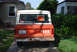 1977 Ford Bronco - This orange Ford Bronco is parked in a driveway with a 'FOR SALE' sign in the rear window.