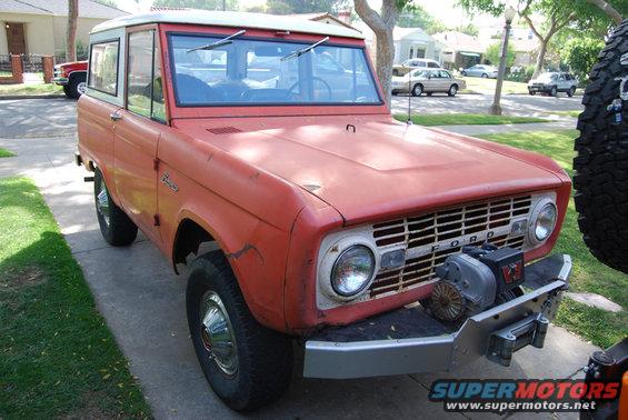 Red 1977 Ford Bronco with winch and spare tire