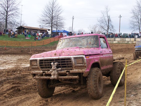 Pink pickup truck with bunny ornament in mud
