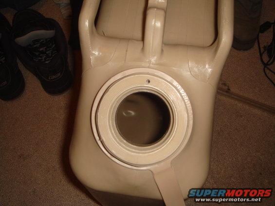 Tan jerry can with a wide opening and threaded cap area
