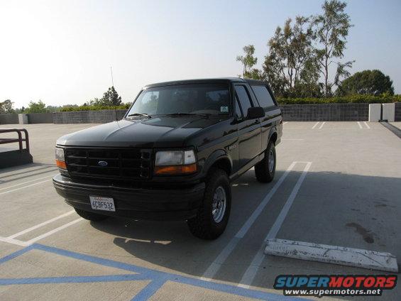 Black Ford Bronco parked in a lot, front passenger side visible. License plate reads 6CBF532