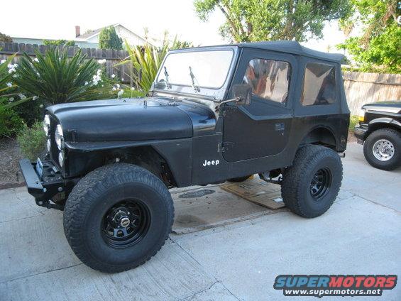 Black Jeep CJ7 with soft top, side view