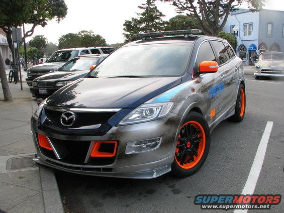 Mazda CX-9 with orange accents and custom graphics parked on street