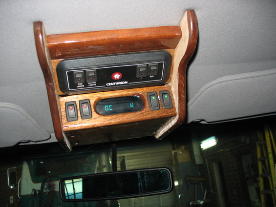 Overhead console with wood trim, Centurion badging, and multiple switches