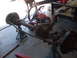 1978 Jeep Cherokee - Front axle assembly on jack stands, with parts of a trailer and other equipment in the background.
