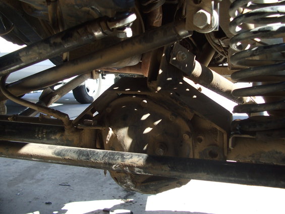 Undercarriage of a vehicle showing suspension components and a differential housing