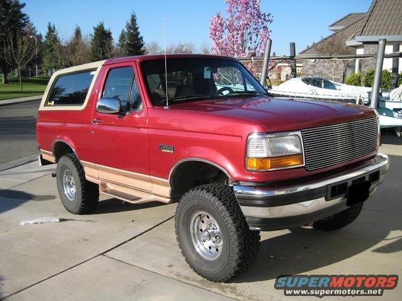 Red 1995 Ford Bronco 3q-front view with tan top