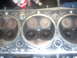 1992 Ford Bronco - Close-up of an engine cylinder head, revealing the condition of the valves and combustion chambers.