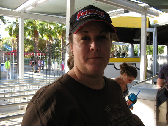 Woman in a black baseball cap with 'Summit Racing Equipment' logo