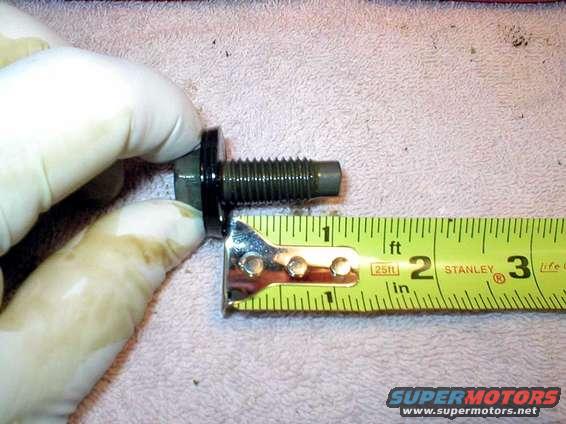 This leads in to the next pic.
It's a 1" long bolt for the oil pan plug.
I use a little inward pressure to keep the oil from leaking out while turning the bolt.
Watch out once it reaches the end of threads.