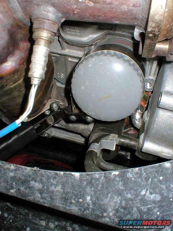 Very tight fit to get at the filter.
View is looking up, just behind the radiator.
I used a "clamp" type oil filter wrench.
A better alternative would be the type that fits over the filter, and you use a 3/8" drive ratchet to free it up.
See last picture in this series for example.