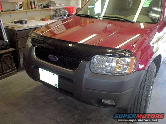 bugflector1.jpg This is what the Ventshade Bugflector II looks like on the Escape.
We picked it up from the local Ford dealer for $52.99.
Time will show how it helps the windsheild, but one thing's for sure.
No more dings on the leading edge of the hood.
Installation is straightforward and doesn't require more than 10 minutes.
The bugflector comes pre-drilled with 4 holes that match existing locations already available on the underside of the hood.