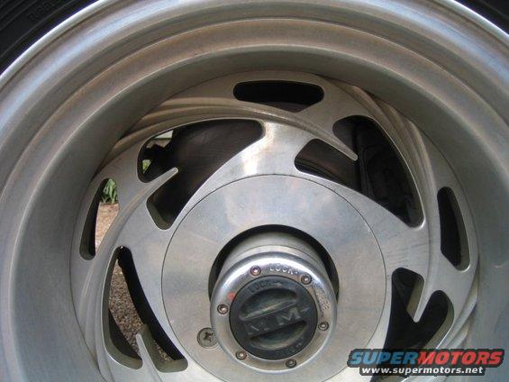Close-up of a silver alloy wheel with a black hub cap labeled "4x4" and "LOCK"