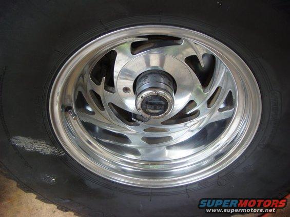 Chrome wheel with a black tire and a center cap reading 'M/T'
