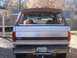 1996 Ford Bronco - A yellow lab peeks out from the back of a 1996 Ford Bronco, which features a removable soft top.