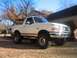 1996 Ford Bronco - White 1996 Ford Bronco with brown trim and aftermarket bull bar parked outside.