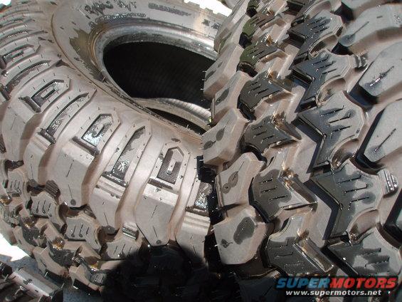 Close-up of aggressive off-road tire tread with visible lettering