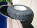 1996 Ford Bronco - A spare tire is mounted externally on the rear of a two-tone SUV, with a portion of the cargo area visible.