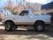 1996 Ford Bronco - This 1996 Ford Bronco features a two-tone paint scheme with a brown stripe accentuating its side profile.